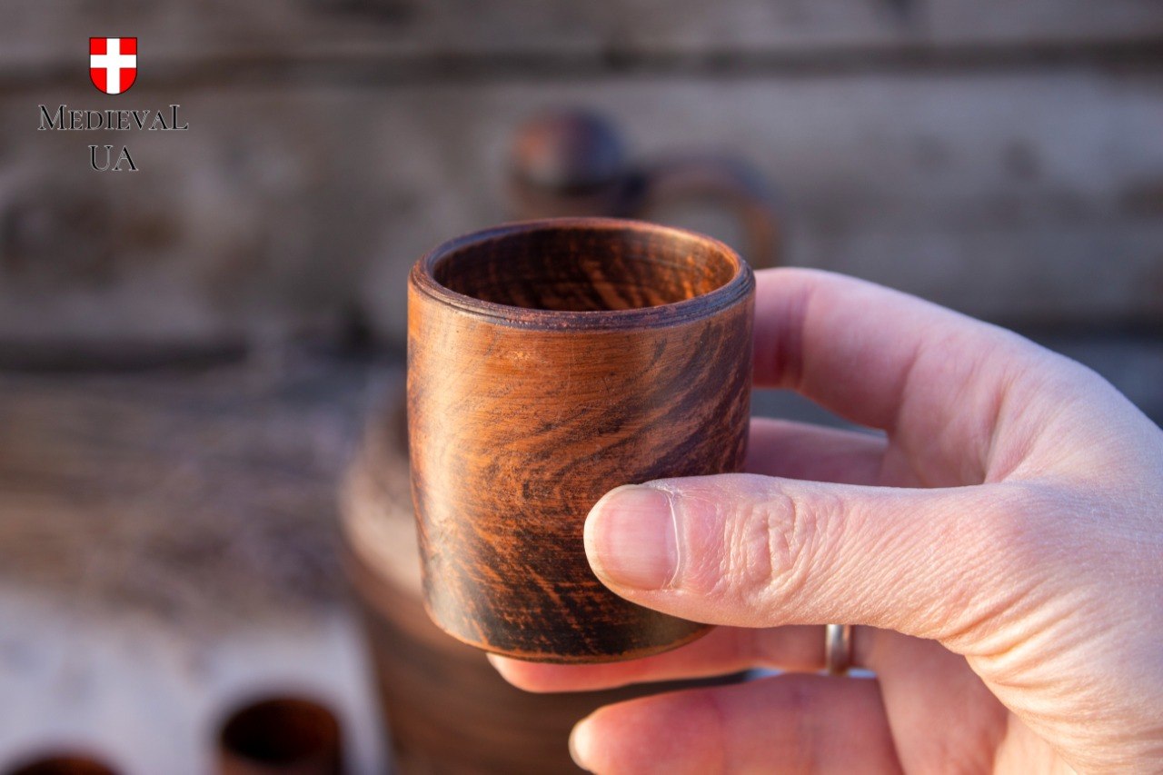 Small handmade clay drinking cup held in the palm, 40 ml pour size