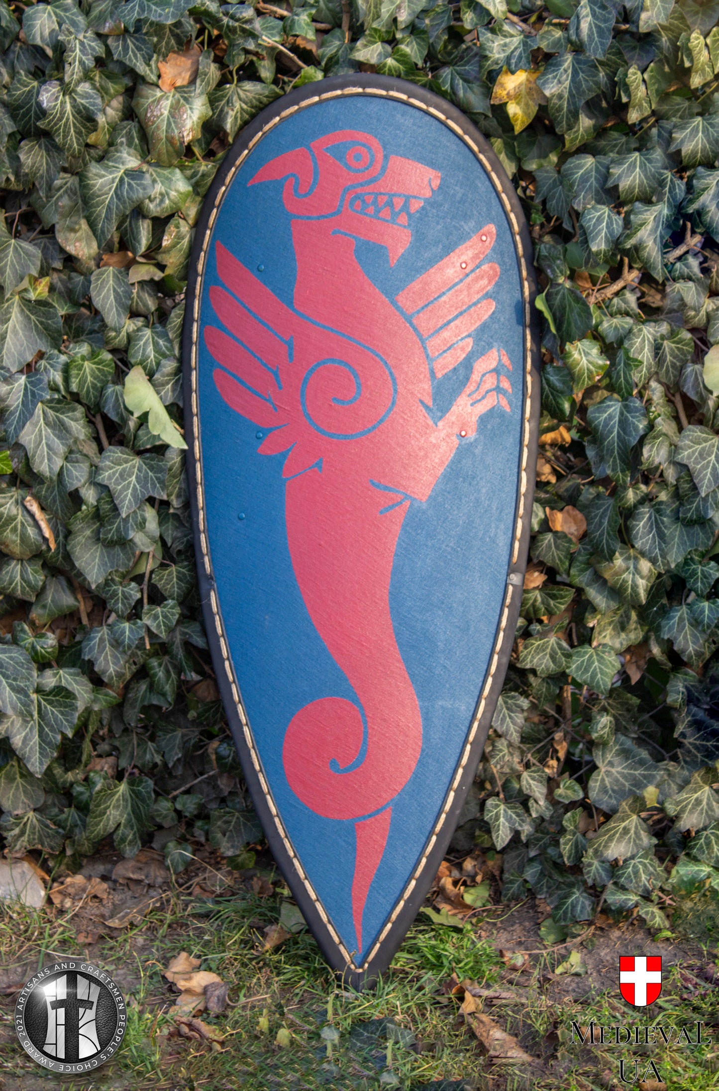 Big dark blue kite medieval shield with a dark red Dragon pattern