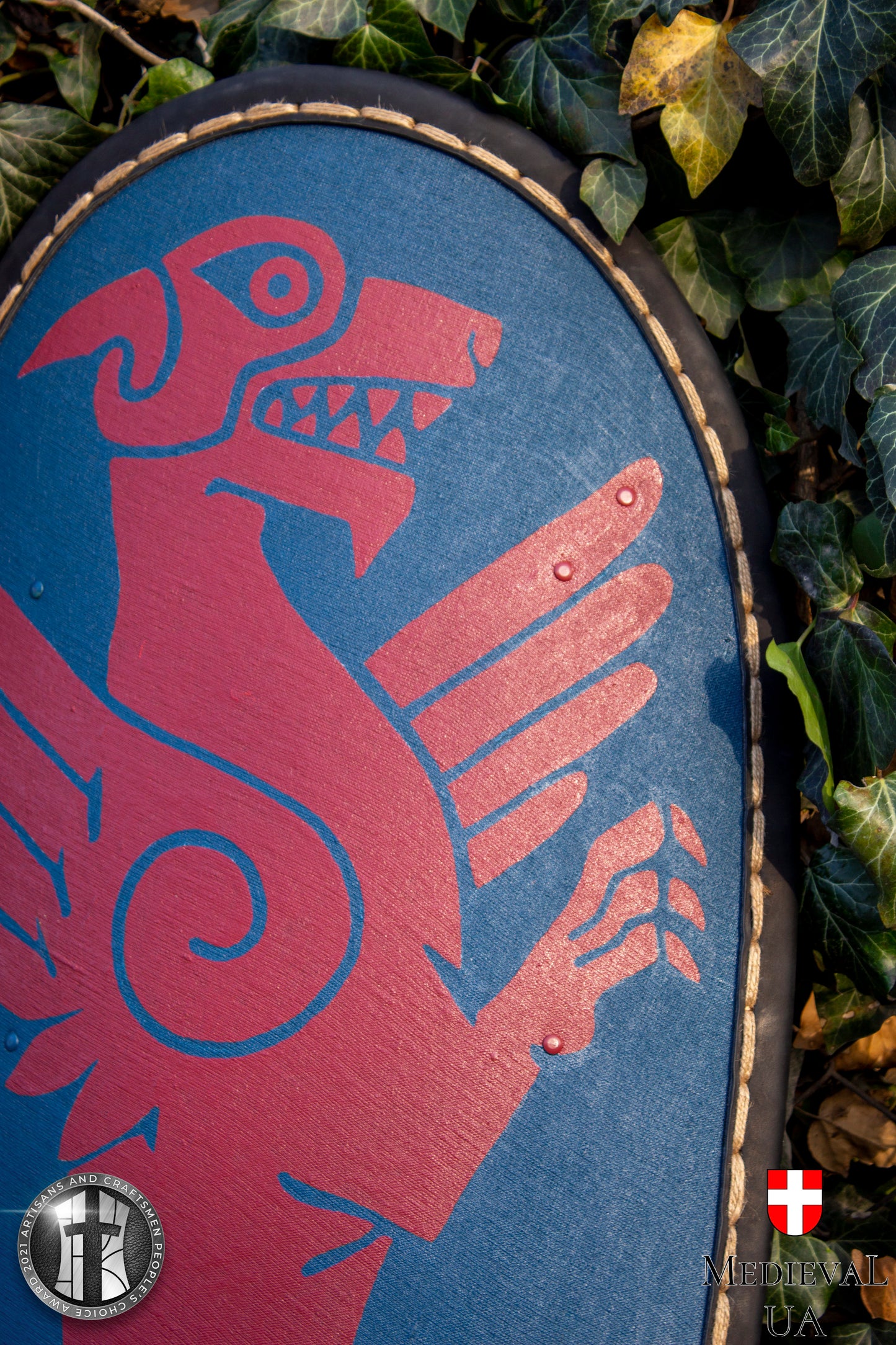 Big dark blue kite medieval shield with a dark red Dragon pattern