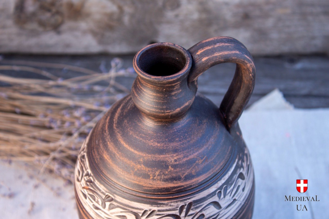 Close-up of the flagon shoulder with hand-carved pale leaf ornament