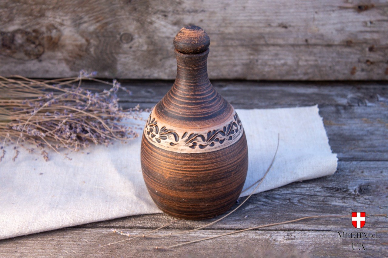Ceramic liqueur botte with carved handmade ornament