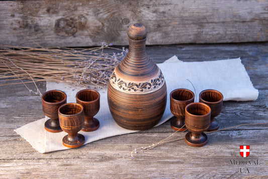Ceramic liqueur set with carved clay bottle and six footed cups