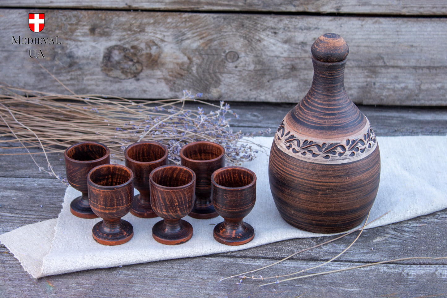 Handmade clay liqueur bottle with six small footed cordial cups