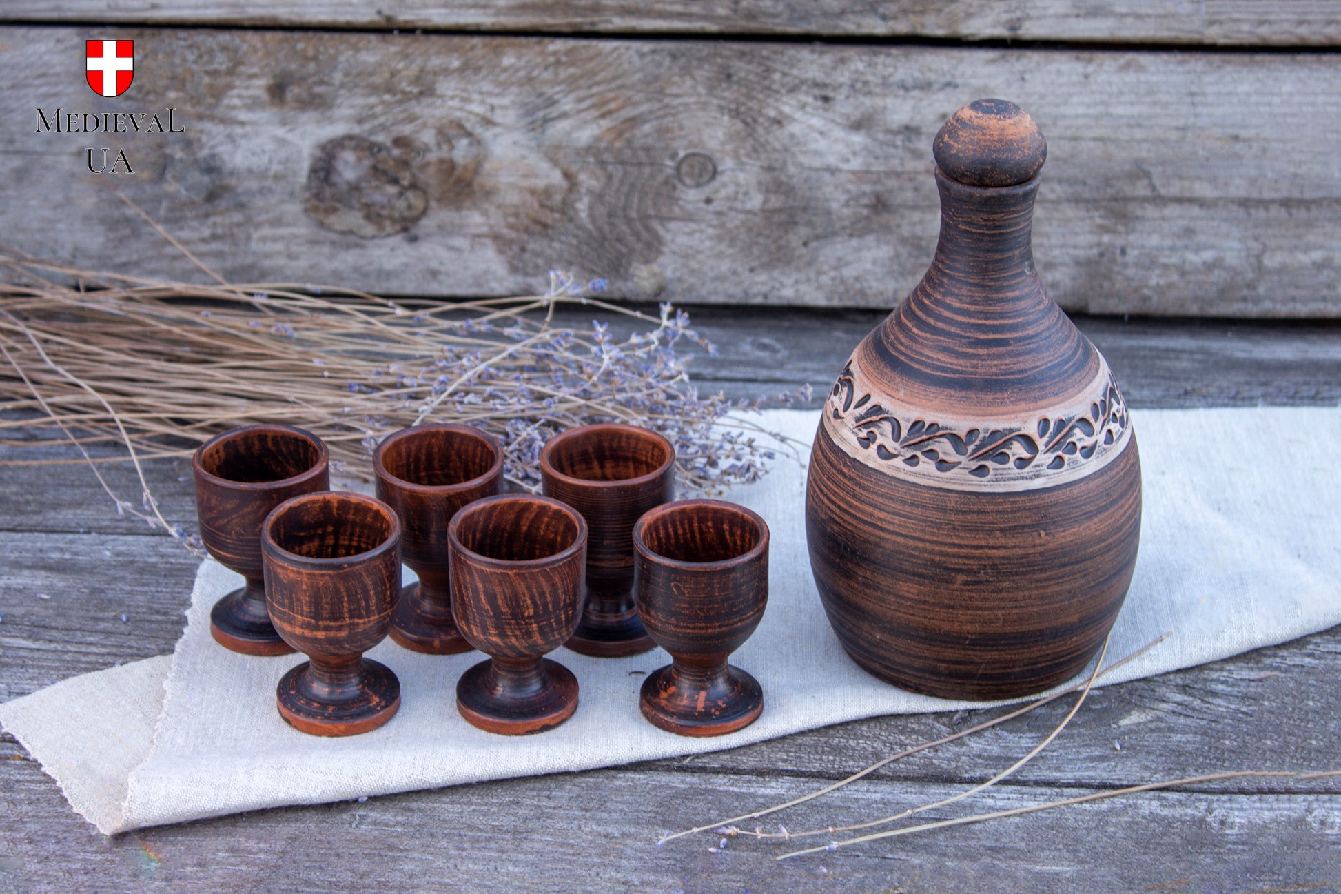 Handmade clay liqueur bottle with six small footed cordial cups