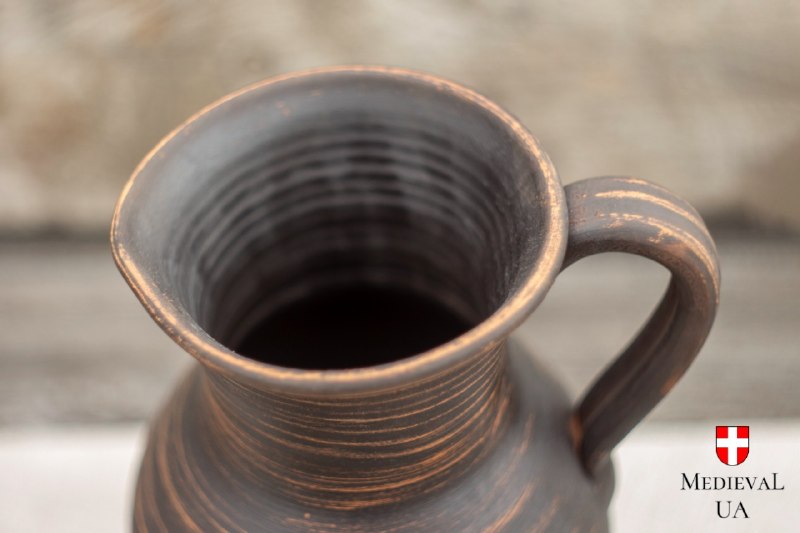 Looking down into the clay pitcher at the spiral wheel marks inside the unglazed body