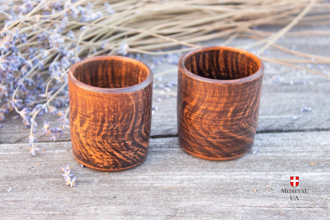 Two clay shot cups showing the smoky markings left by milk firing