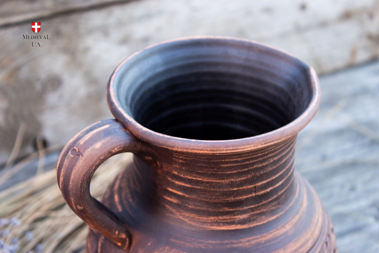 Top view of medieval clay pitcher showing wide neck and handle