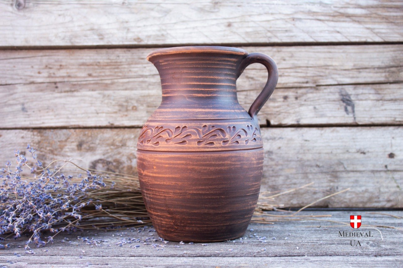 Rustic ceramic serving jug with hand-carved floral ornament