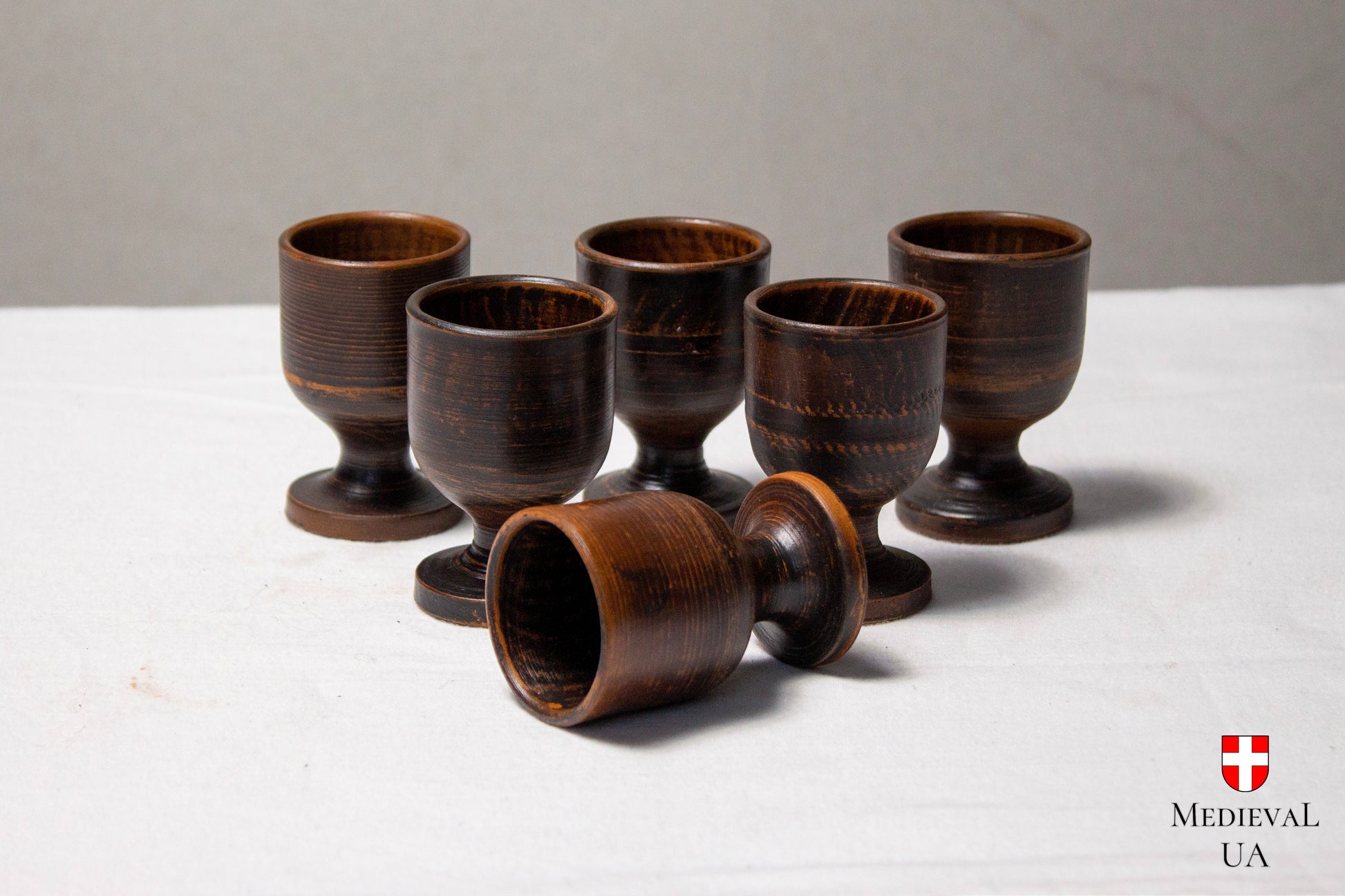Six footed clay cups for a wine and spirits serving set