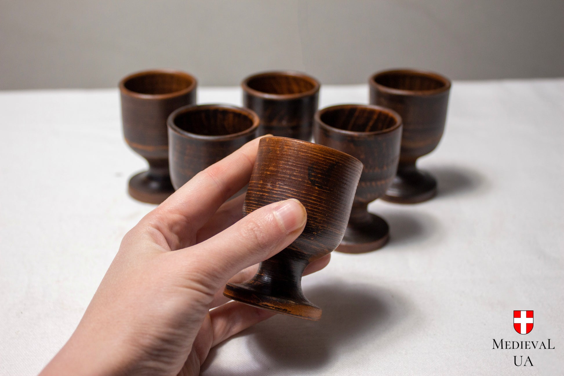 Set of six handmade ceramic cordial cups on turned clay feet