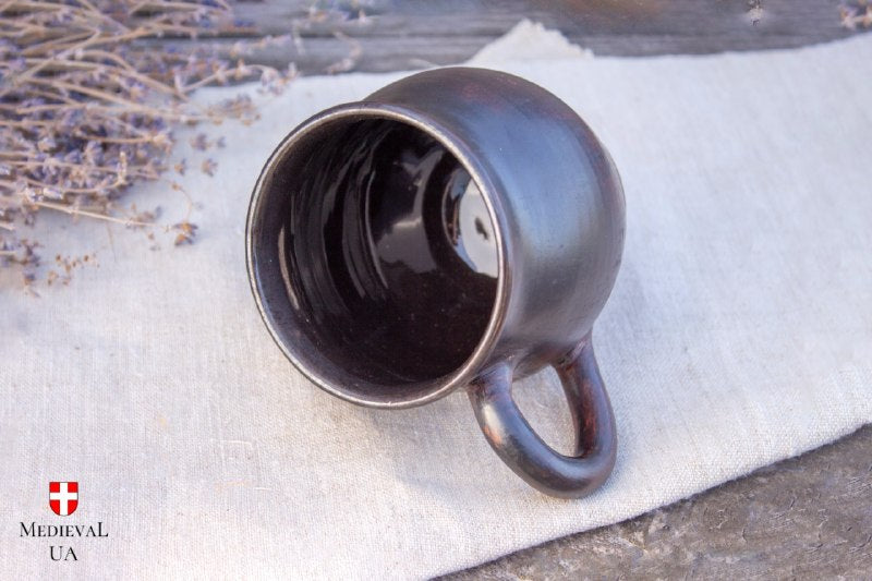 Top view of the dark ceramic mug showing the glossy black food-safe glazed interior