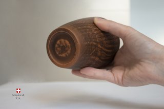 Rustic LARP clay cup shown next to a hand for scale, bottom view