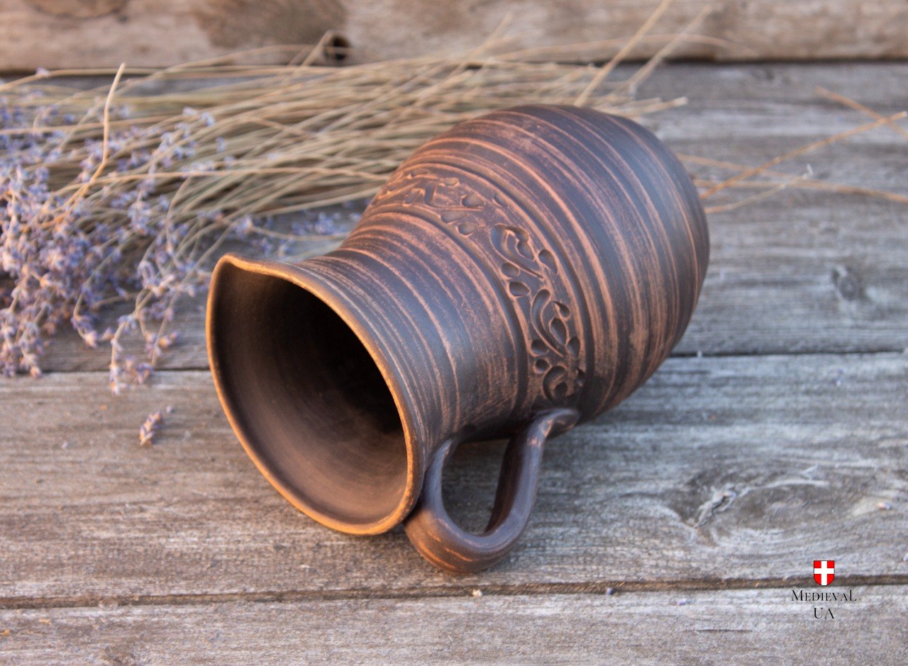 Rustic clay jug top view showing glazed interior and rim