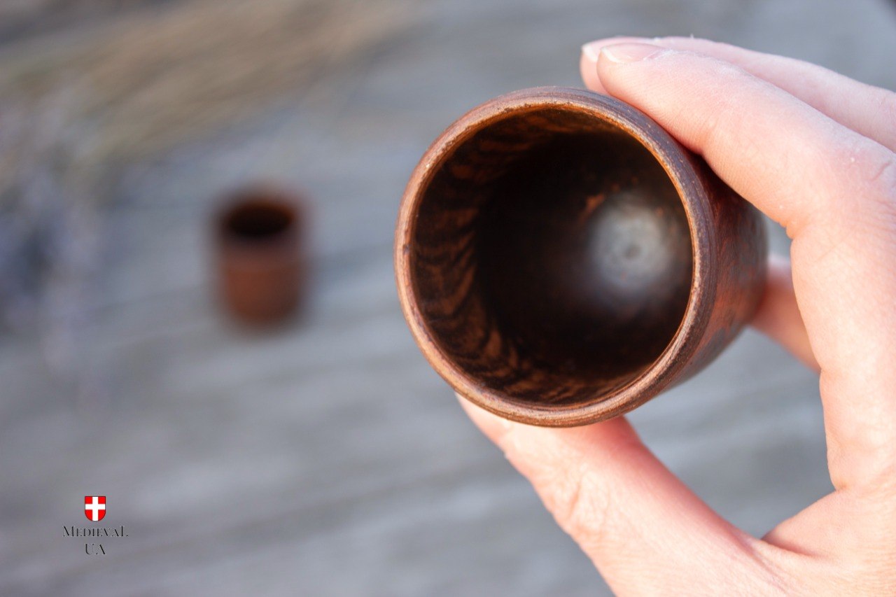 Inside of an unglazed ceramic shot glass showing bare clay walls